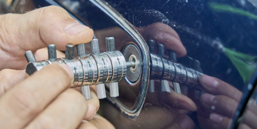 Locksmith using tool on a car door